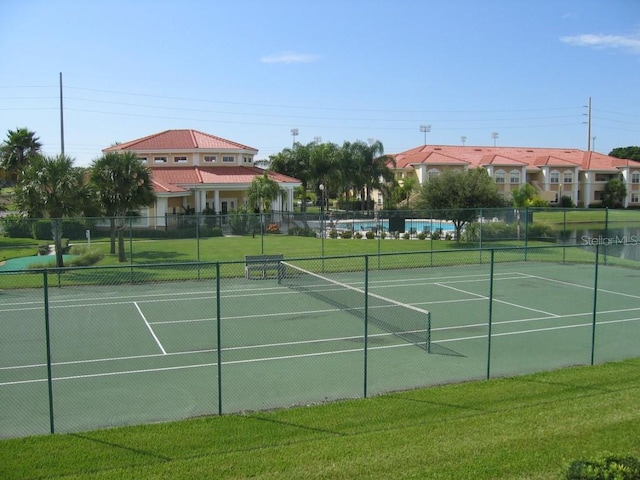 view of sport court featuring a lawn