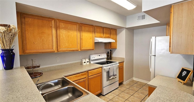 kitchen with sink, white appliances, and light tile patterned floors