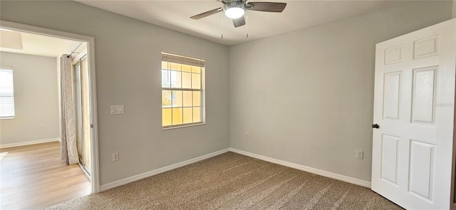 carpeted spare room featuring ceiling fan