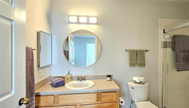 bathroom with an enclosed shower, vanity, and toilet