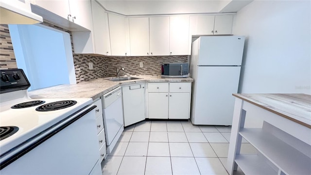 kitchen with white cabinetry, white appliances, and tasteful backsplash