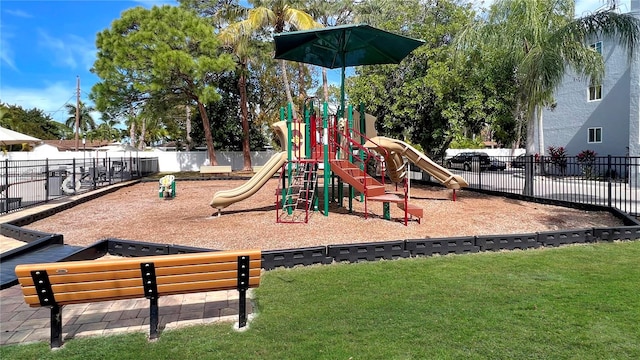 view of jungle gym featuring a lawn