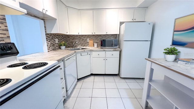 kitchen featuring white cabinets, tasteful backsplash, and white appliances