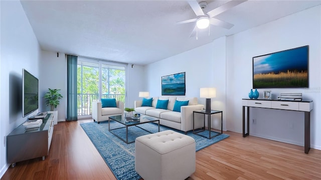 living room featuring light hardwood / wood-style flooring and ceiling fan