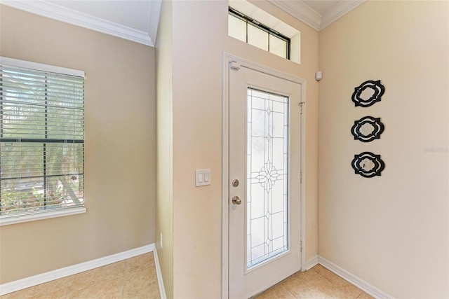 tiled foyer with ornamental molding and a healthy amount of sunlight