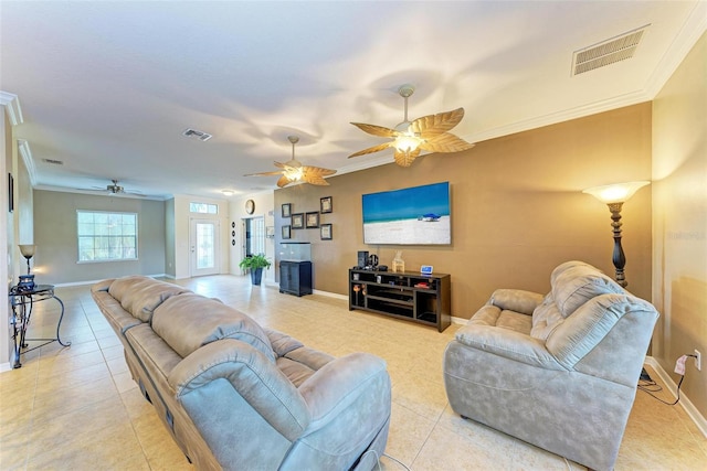 living room with crown molding, light tile patterned floors, and ceiling fan