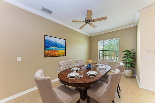 tiled dining space featuring ceiling fan and ornamental molding