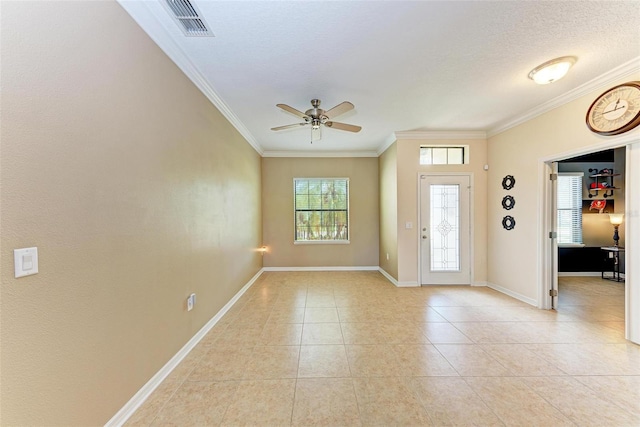 tiled entryway featuring ceiling fan, ornamental molding, and a textured ceiling