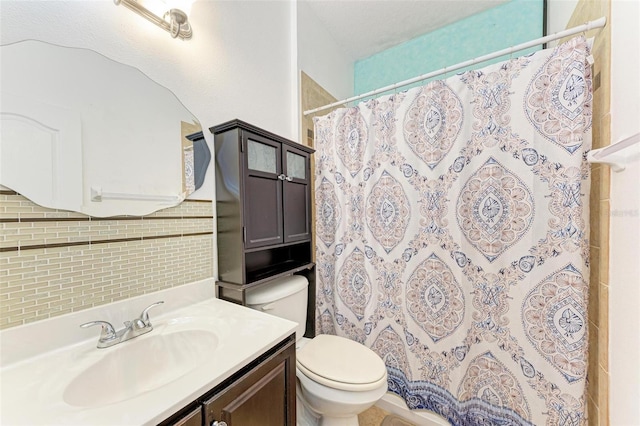 bathroom featuring toilet, curtained shower, vanity, and backsplash