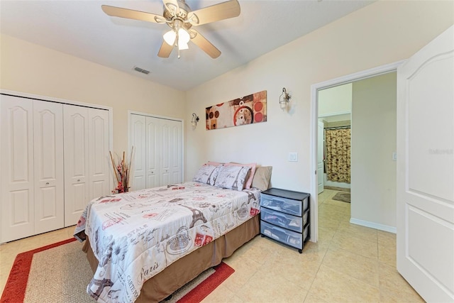 tiled bedroom with multiple closets and ceiling fan