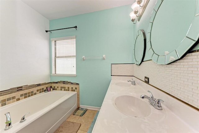 bathroom featuring vanity, tile patterned floors, a washtub, and backsplash