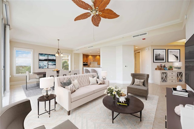 living room featuring ceiling fan, ornamental molding, and light tile patterned flooring