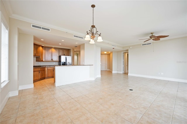 kitchen with hanging light fixtures, crown molding, stainless steel refrigerator with ice dispenser, and plenty of natural light