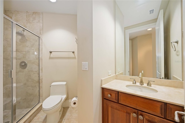 bathroom featuring vanity, tile patterned flooring, toilet, and walk in shower