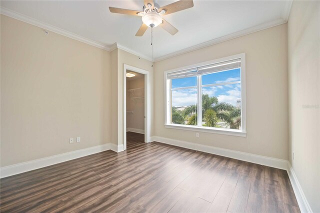 spare room featuring ceiling fan, ornamental molding, and dark hardwood / wood-style flooring