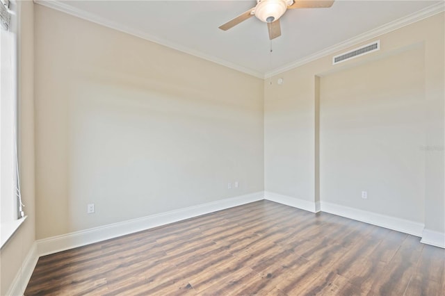 spare room featuring ornamental molding and dark hardwood / wood-style floors