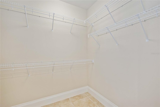 walk in closet with tile patterned floors