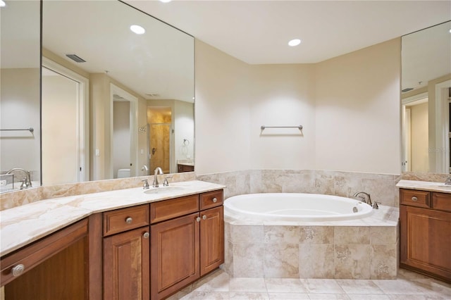 bathroom with vanity, shower with separate bathtub, and tile patterned flooring