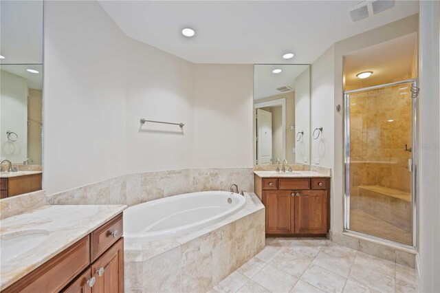 bathroom featuring vanity, plus walk in shower, and tile patterned floors