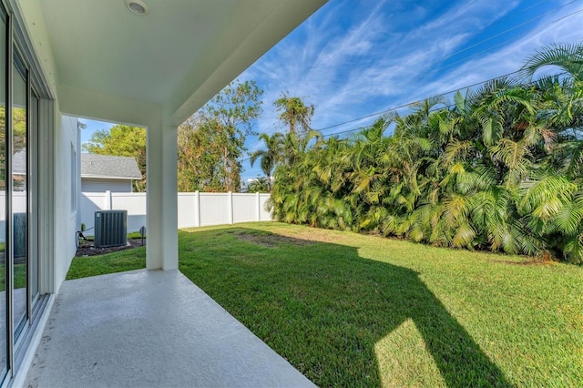 view of yard featuring central AC unit and a patio area