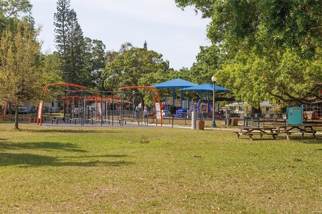 community jungle gym featuring a yard