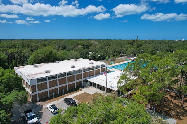 drone / aerial view with a wooded view