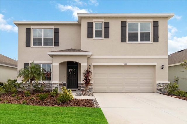 view of front of house featuring a garage and a front lawn