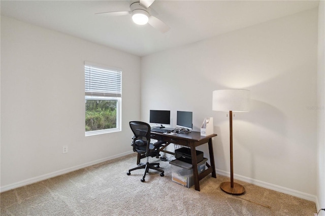 carpeted home office with ceiling fan