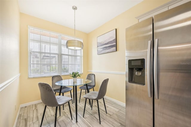 dining space featuring light wood-type flooring and plenty of natural light