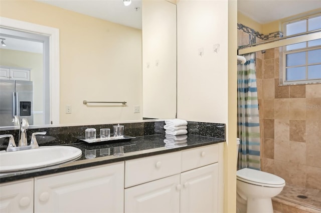 bathroom featuring vanity, toilet, and a shower with shower curtain