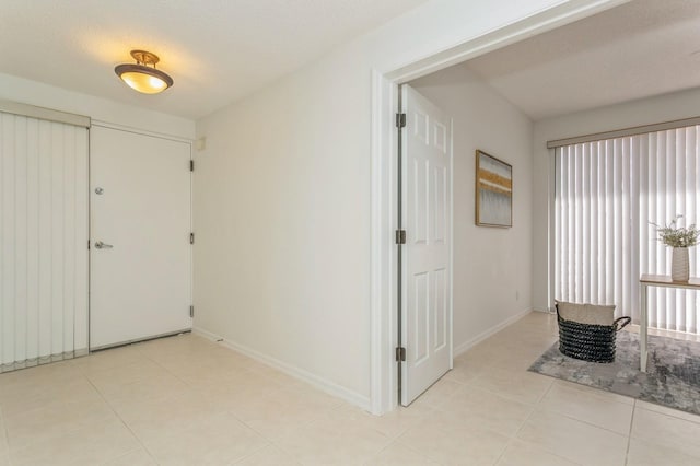 tiled entrance foyer with a textured ceiling