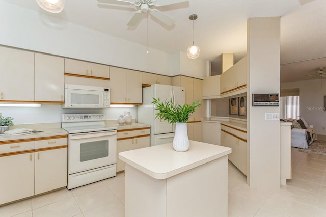 kitchen with a center island, white appliances, and light tile patterned floors