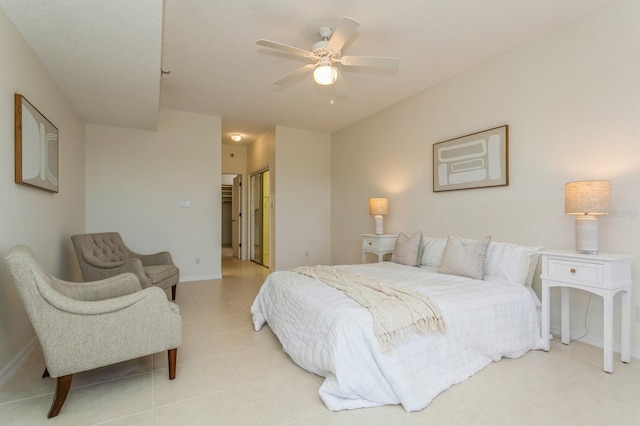 bedroom with ceiling fan and light tile patterned flooring