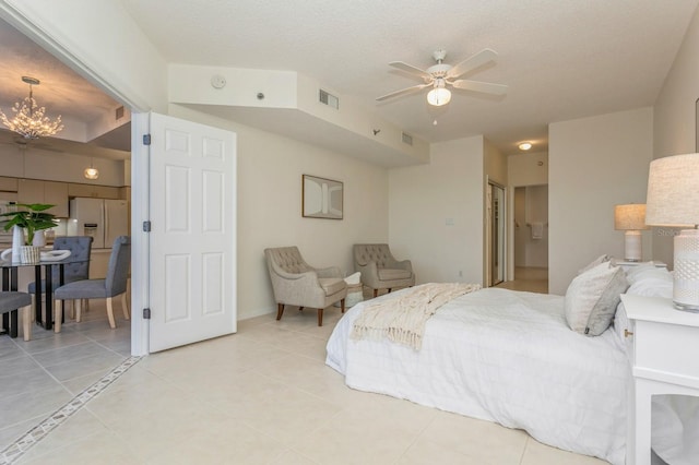 bedroom with a closet, white refrigerator with ice dispenser, light tile patterned floors, a textured ceiling, and ceiling fan with notable chandelier