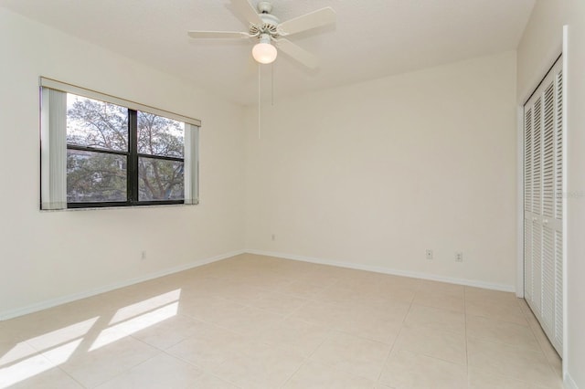 unfurnished bedroom featuring a closet, light tile patterned floors, and ceiling fan