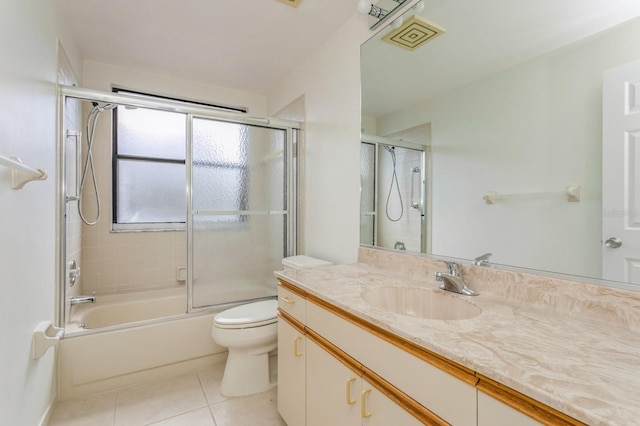 full bathroom featuring vanity, toilet, enclosed tub / shower combo, and tile patterned flooring