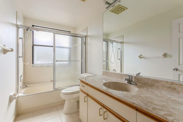 full bathroom with vanity, toilet, tile patterned floors, and shower / bath combination with glass door