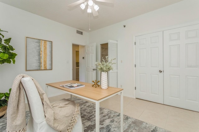 home office featuring ceiling fan, a textured ceiling, and light tile patterned floors