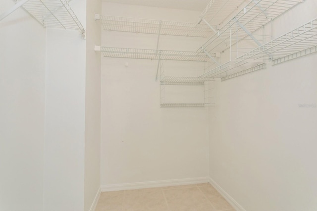 spacious closet with tile patterned floors