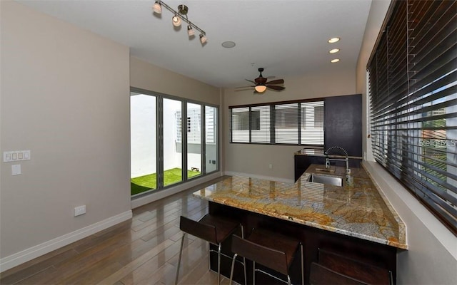 interior space with baseboards, recessed lighting, ceiling fan, and wood finished floors