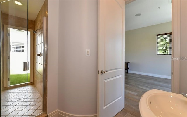 bathroom with baseboards, a sink, and wood finished floors
