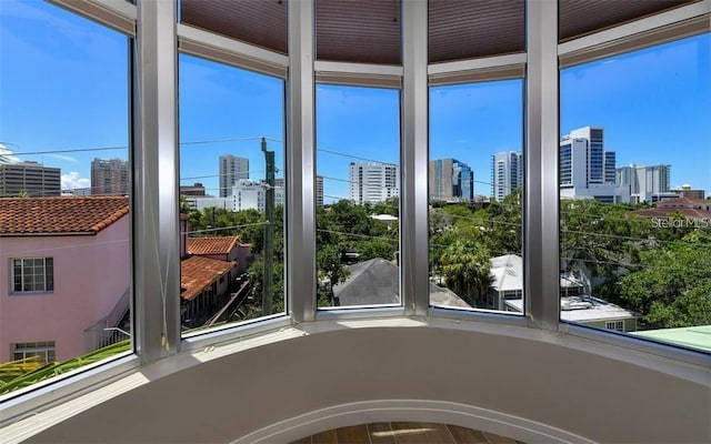 unfurnished sunroom with a city view