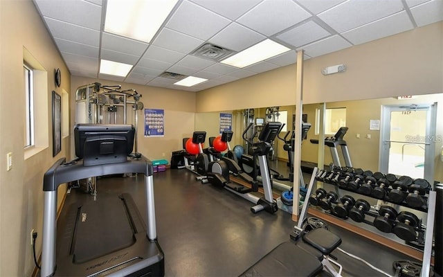 workout area featuring visible vents and a paneled ceiling