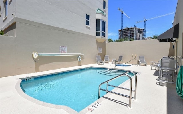 view of swimming pool featuring a patio