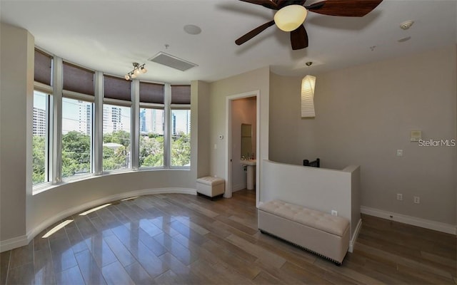unfurnished room with baseboards, visible vents, and wood finished floors