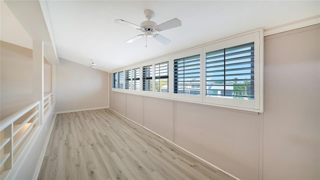 empty room featuring light hardwood / wood-style flooring, a wealth of natural light, and ceiling fan