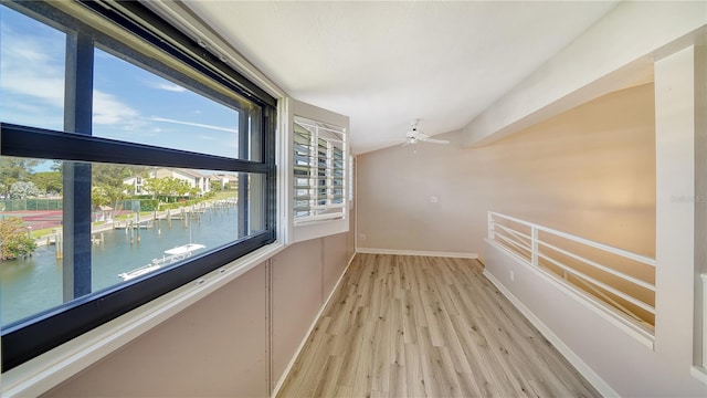 hallway featuring light hardwood / wood-style flooring and a water view