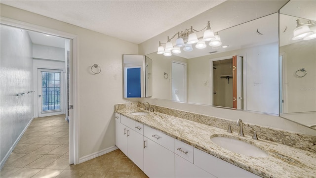 bathroom with vanity, tile patterned floors, and a textured ceiling