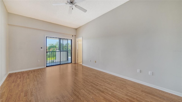 unfurnished room featuring a textured ceiling, ceiling fan, light wood-type flooring, and vaulted ceiling