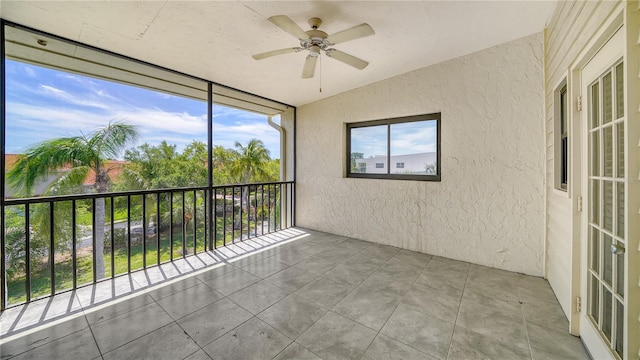 unfurnished sunroom with vaulted ceiling and ceiling fan